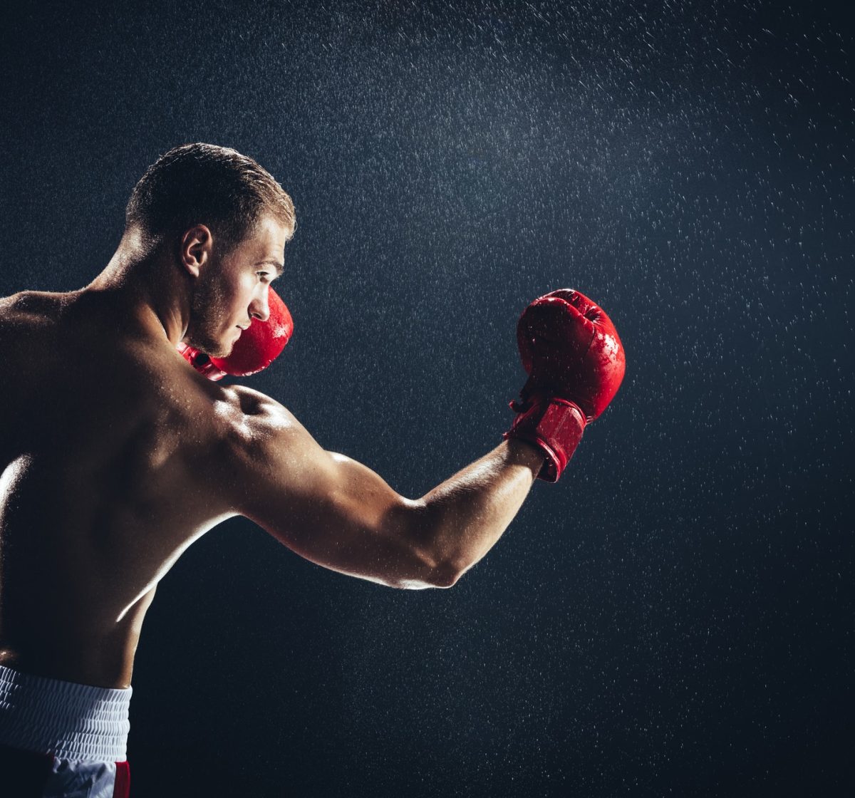 man-boxing-with-red-gloves-on-his-hands-in-the-rain-.jpg